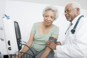 Senior woman having her blood pressure checked by her doctor