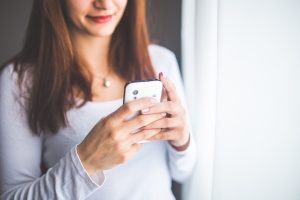 photo of woman using a smartphone