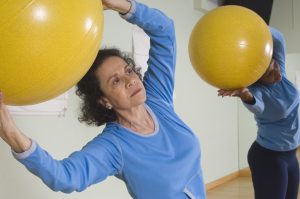 Photo of Senior Woman Using Exercise Ball in Fitness Class